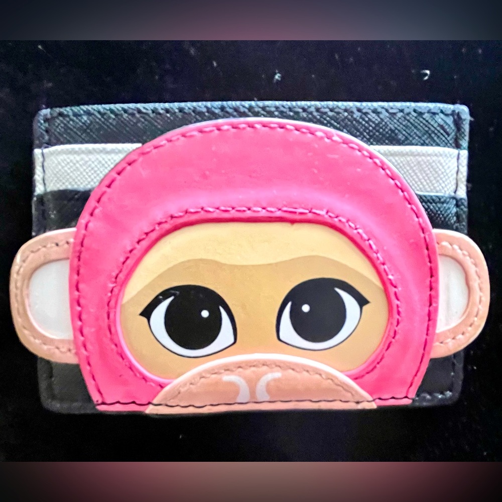 A Striped Kate Spade New York Credit  Card Case with a Colorful Monkey Graphic.